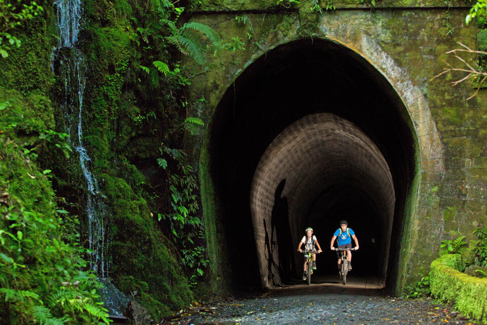 Remutaka Cycle Trail tunnel Two cyclists in Summit Tunnel with headlamps credit Caleb Smith
