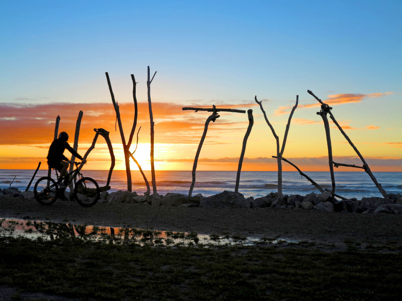 West Coast Wilderness Trail Hokitika sign bike and sunset credit Craig Wilson