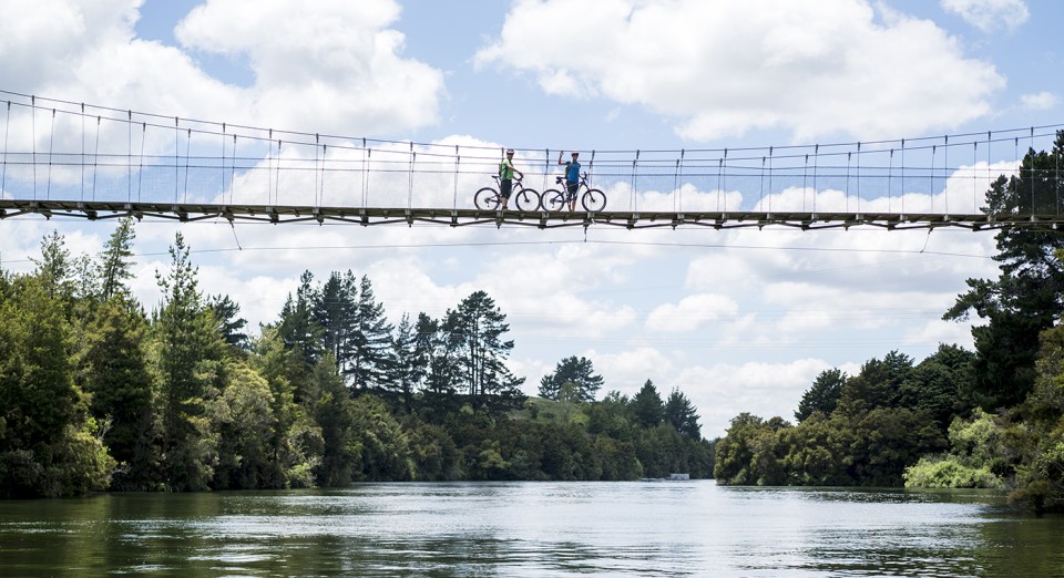 Waikato River Trails Two cyclists on suspension bridge credit Waikato River Trails